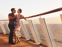 couple standing with glasses white wine on cruise ship